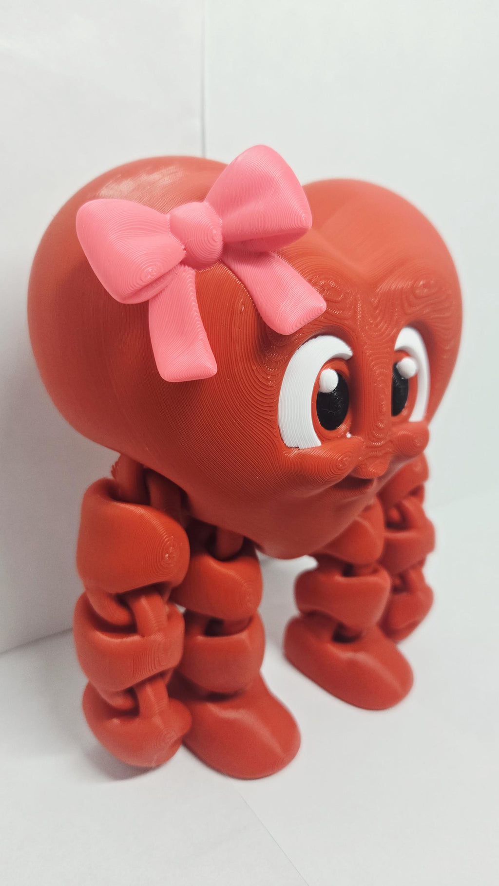 A three-quarters angle view of the standing Valentine heart decoration showcasing its smooth, rounded curves and polished edges