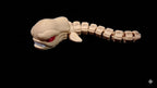 Side profile of the segmented 3D printed Chestburster figure showcasing its articulated, slithering anatomy