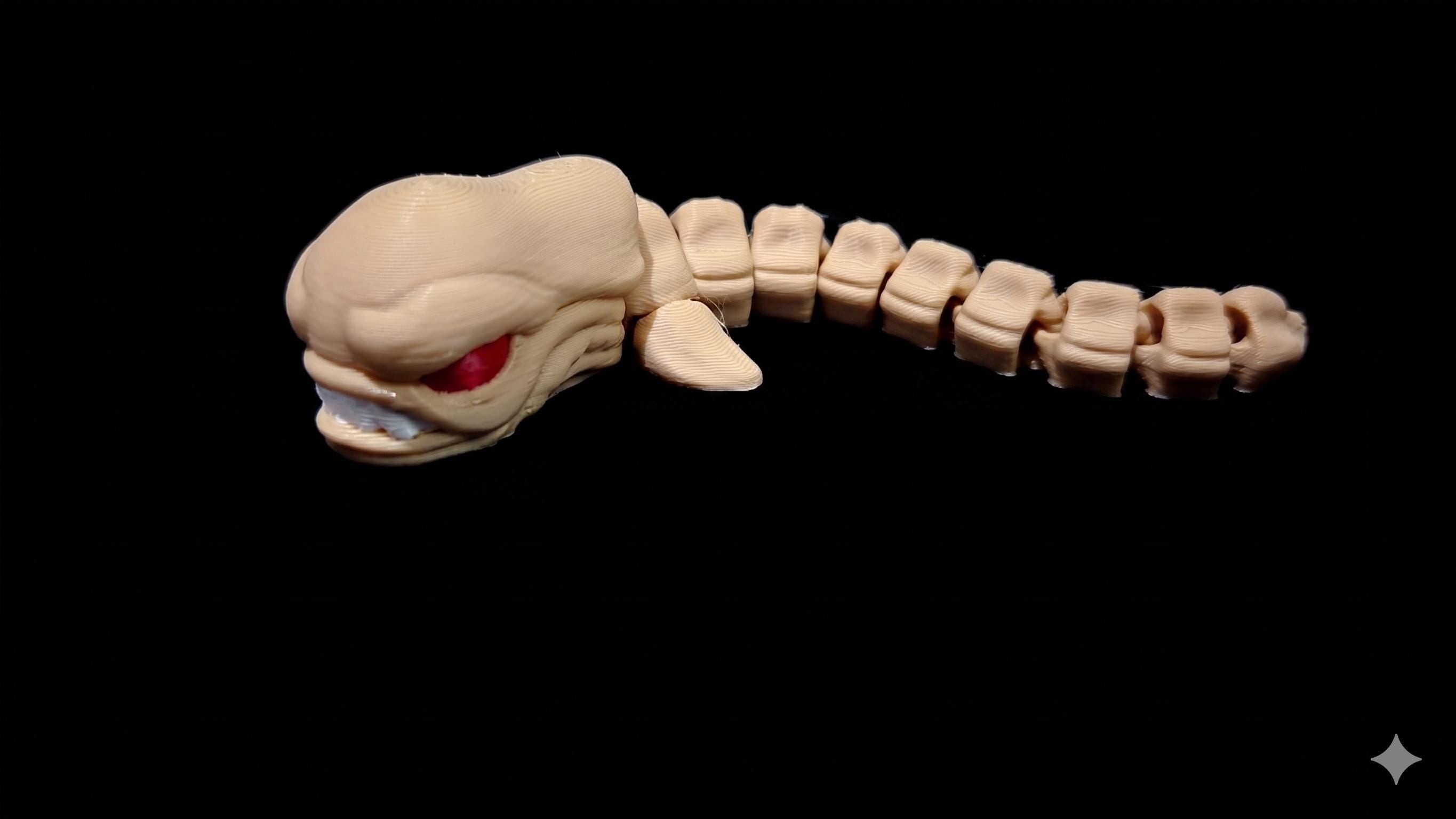 Side profile of the segmented 3D printed Chestburster figure showcasing its articulated, slithering anatomy