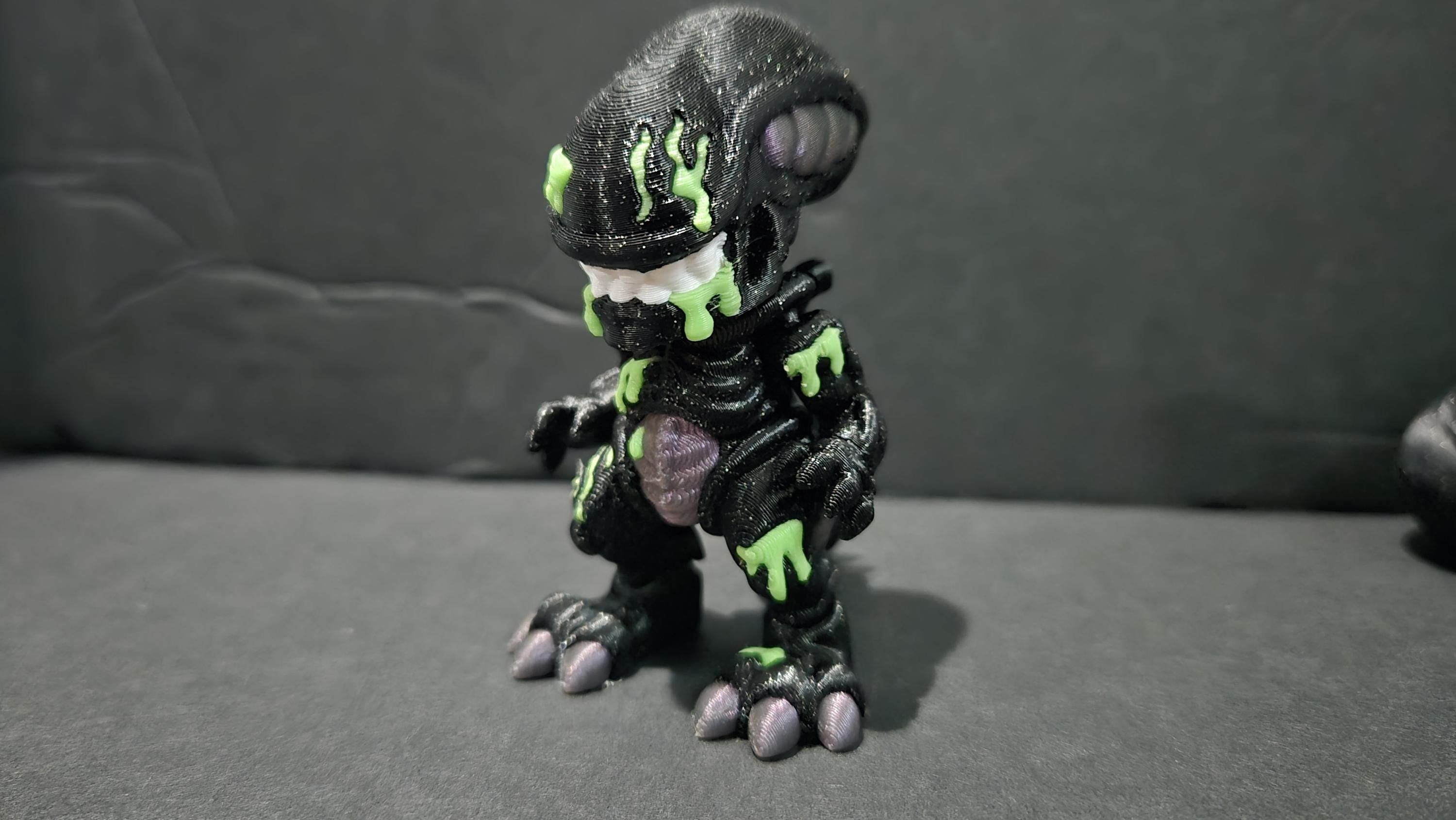 Full-grown 3D printed Xenomorph warrior with acid-green highlights standing in a classic hunting pose