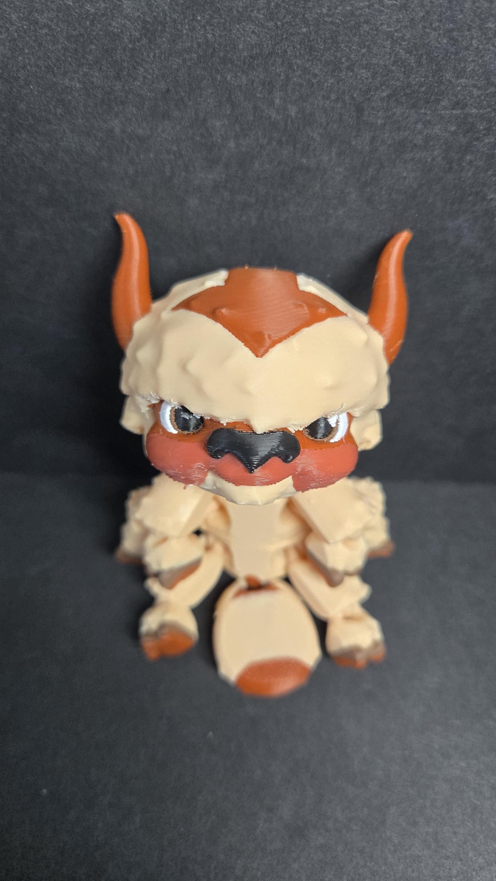 Front close-up view of the flexible Appa figure highlighting his brown horns and arrow marking
