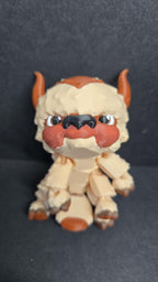 Straight front view of the articulated Appa flexi figure sitting on a flat surface