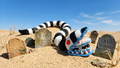 3D printed Beetlejuice sandworm flexi figure crawling through a sandy graveyard display scene