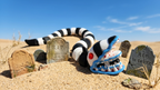 3D printed Beetlejuice sandworm flexi figure crawling through a sandy graveyard display scene