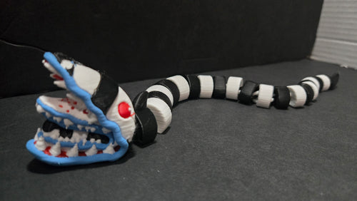 Articulated Beetlejuice sandworm figure stretched out in an S-curve pose