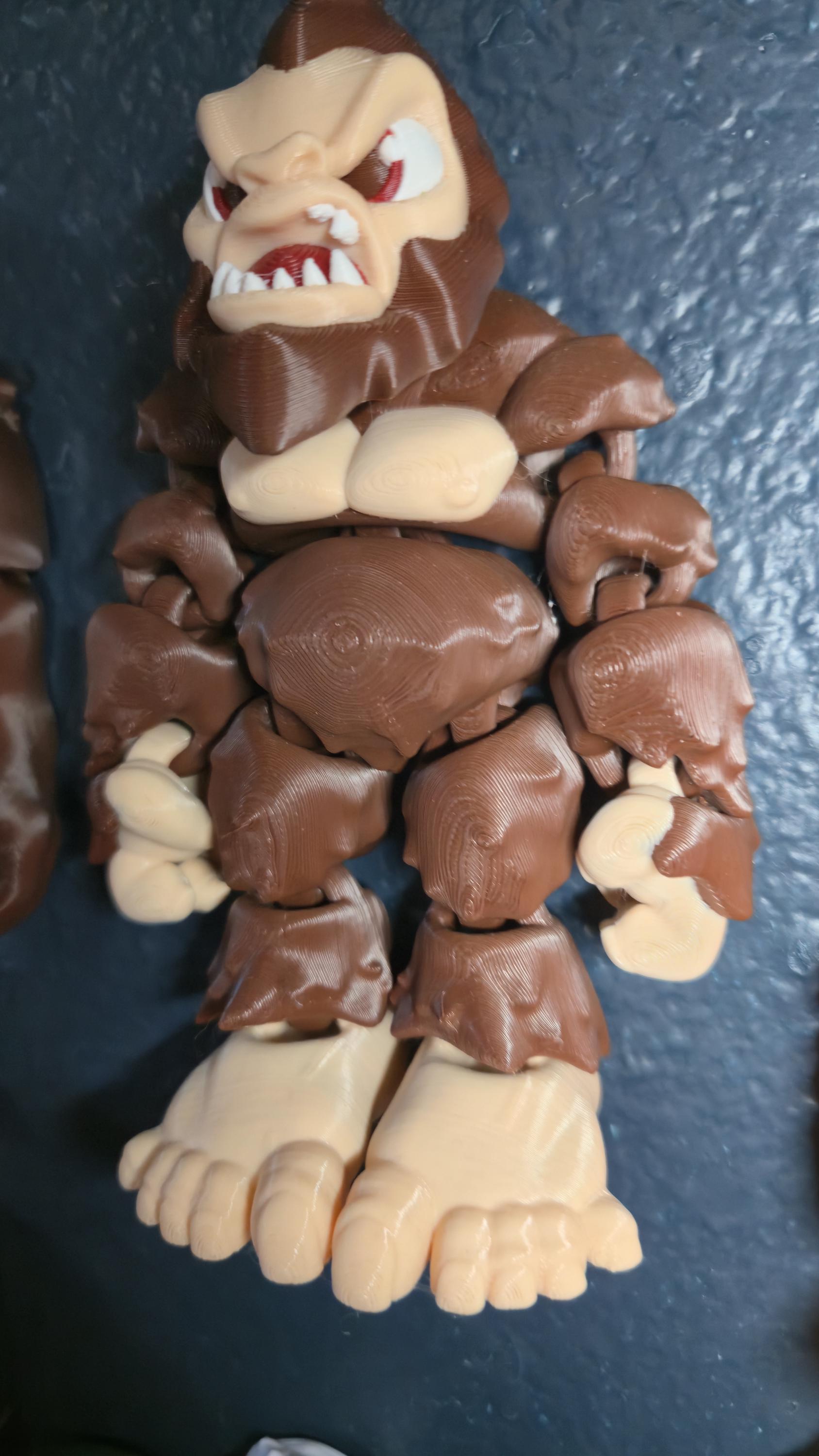 Left side profile view of the flexible Sasquatch toy showing the distinct silhouette and arm articulation joints