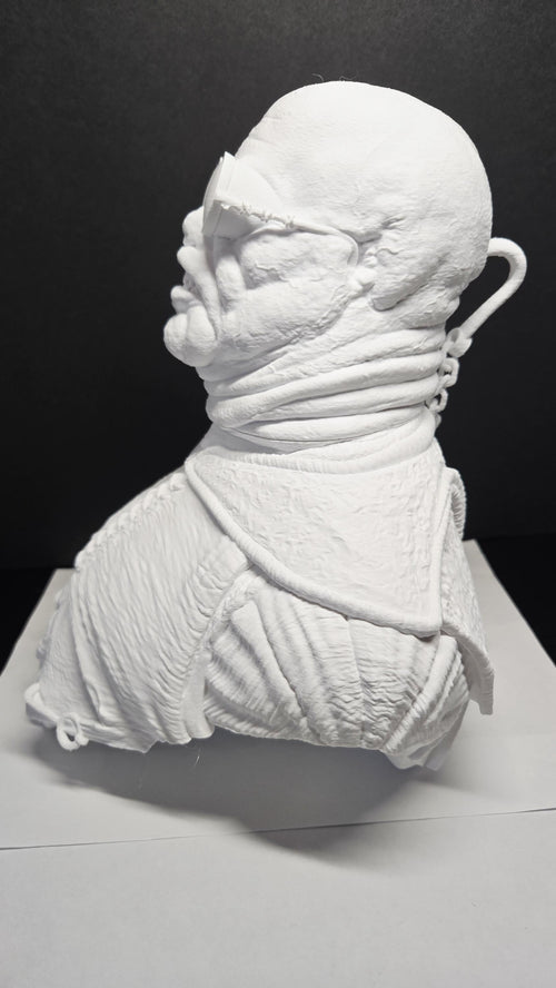 Left side profile of the unpainted Cenobite sculpture showing jawline details and smooth layer transitions