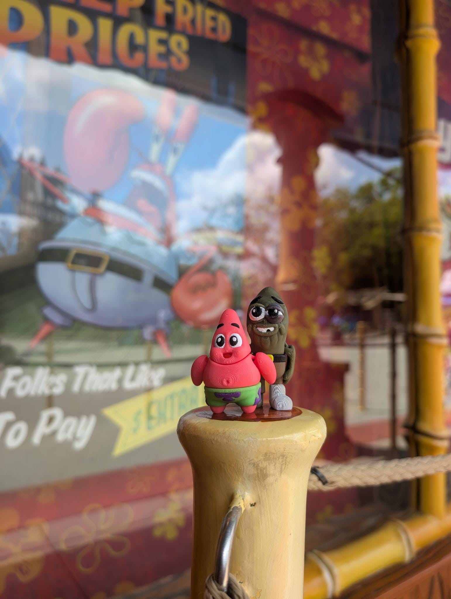 Small cartoon mini-figures displayed on a pillar in front of a themed store window
