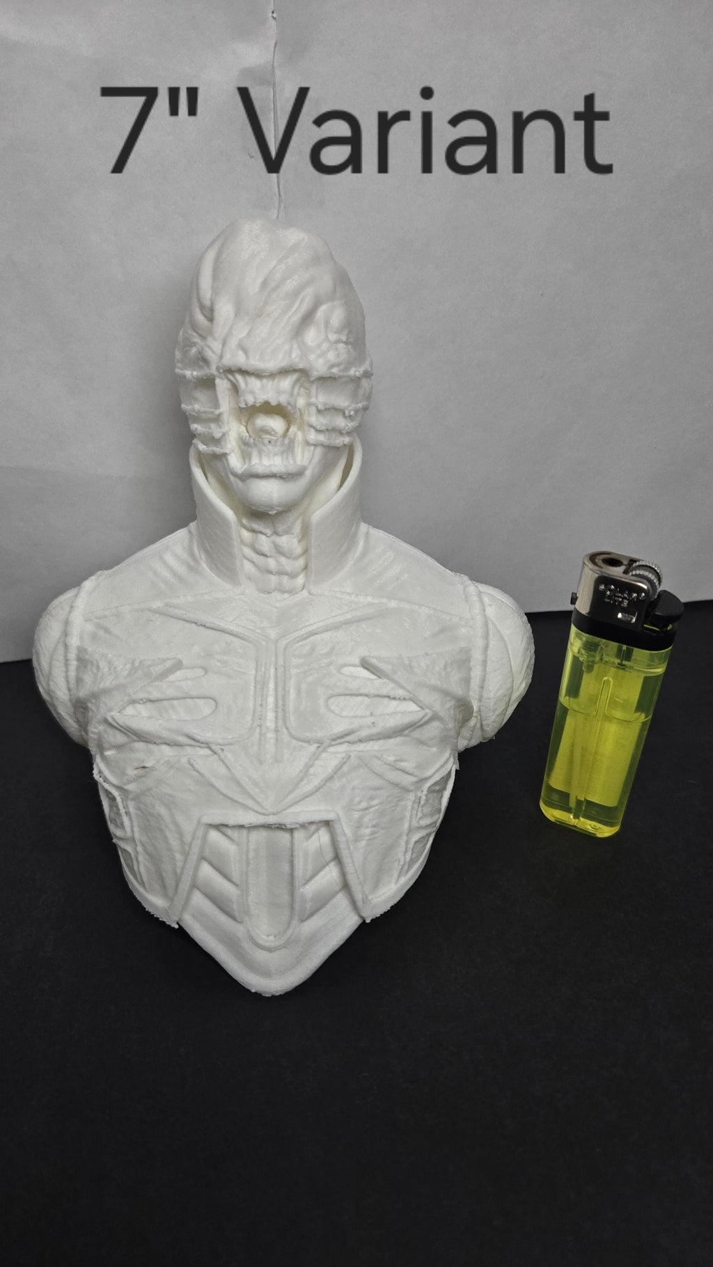 Close-up of the 7-inch variant of the Chatterer Cenobite bust next to a lighter for scale reference