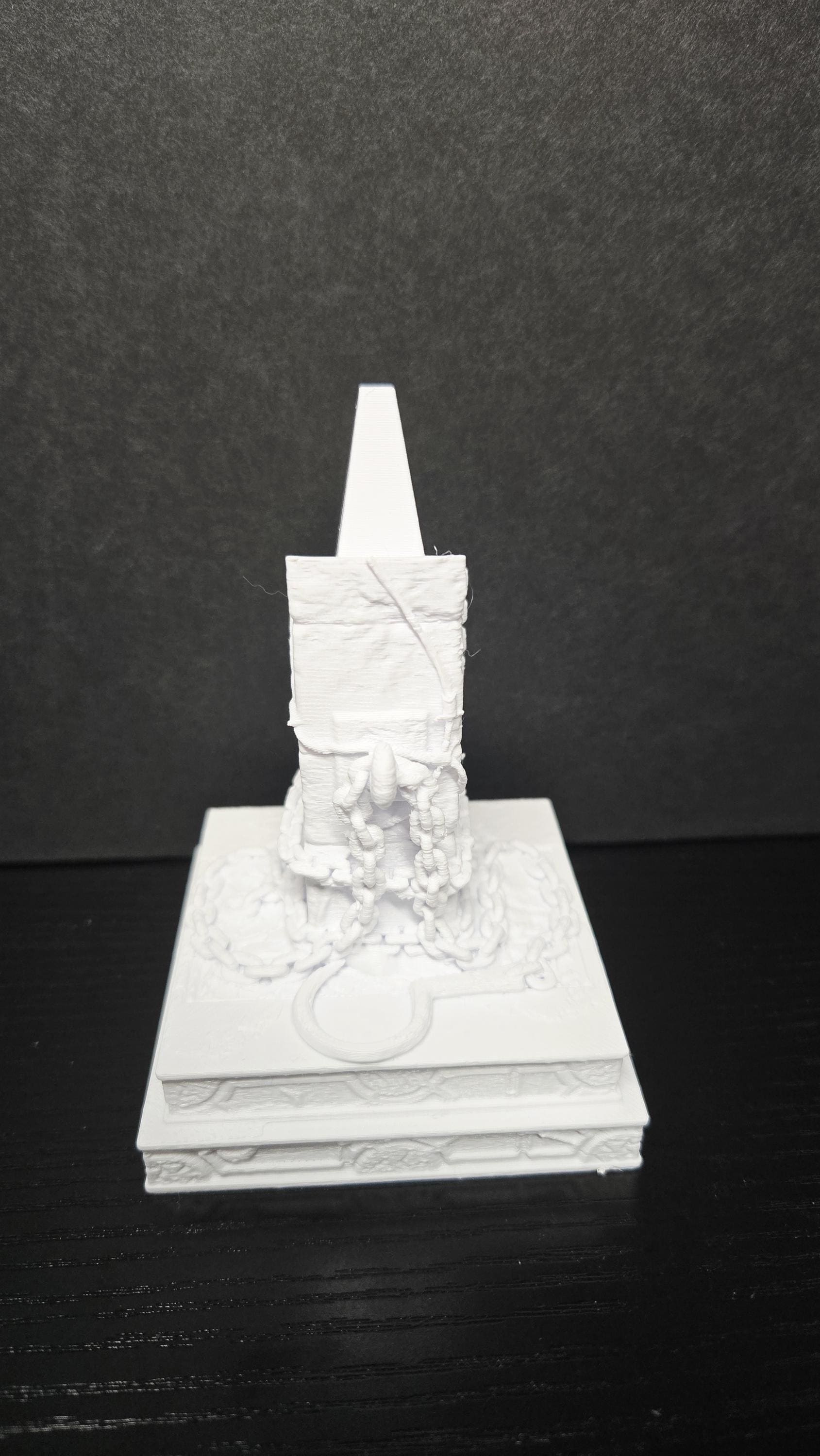 Rear view of the unpainted 3D printed pedestal display base showing the structural support