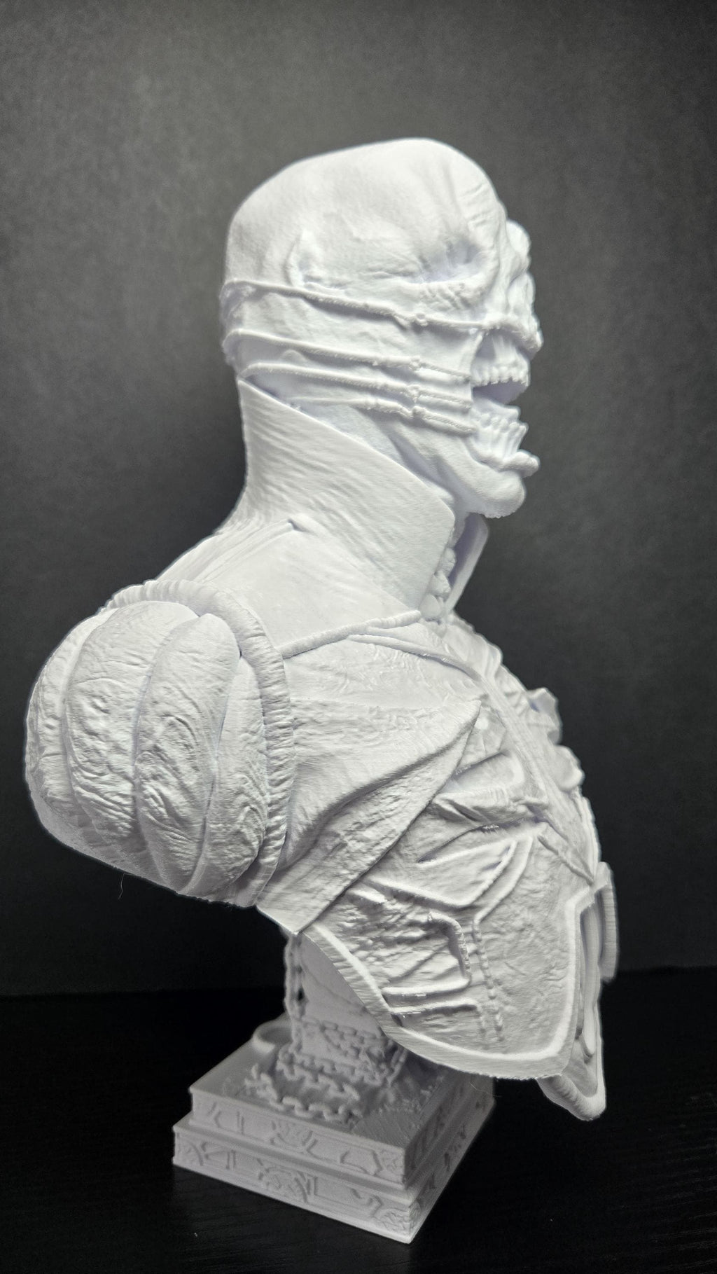Three-quarter right side view of the unpainted Chatterer bust highlighting the leather armor texture and head detail