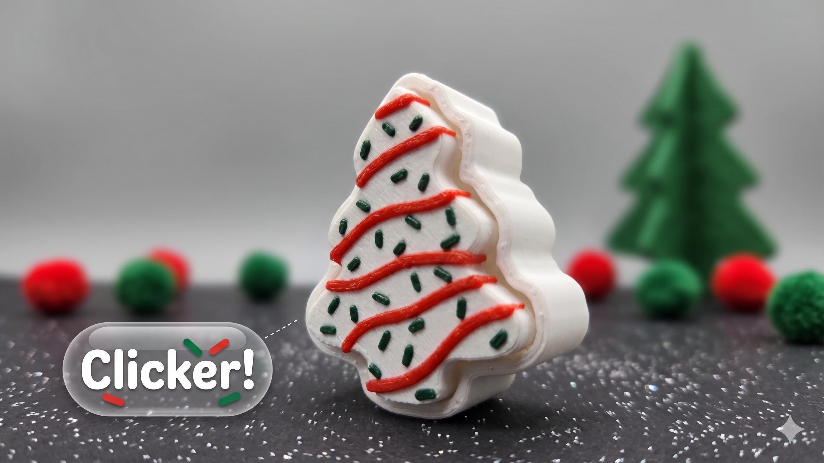 3D printed Christmas tree snack cake fidget clicker sitting on a dark surface with festive holiday decorations in the background