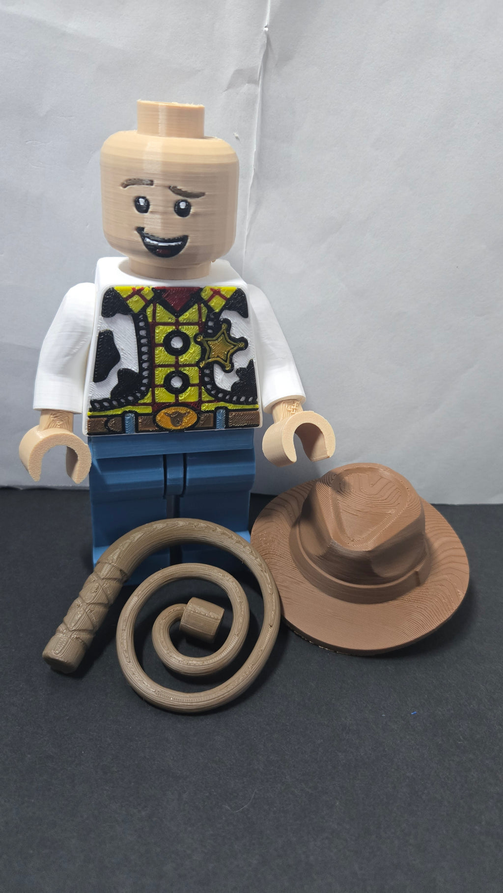 Cowboy sheriff brick megafig shown with the cowboy hat removed alongside the hat and lasso accessories