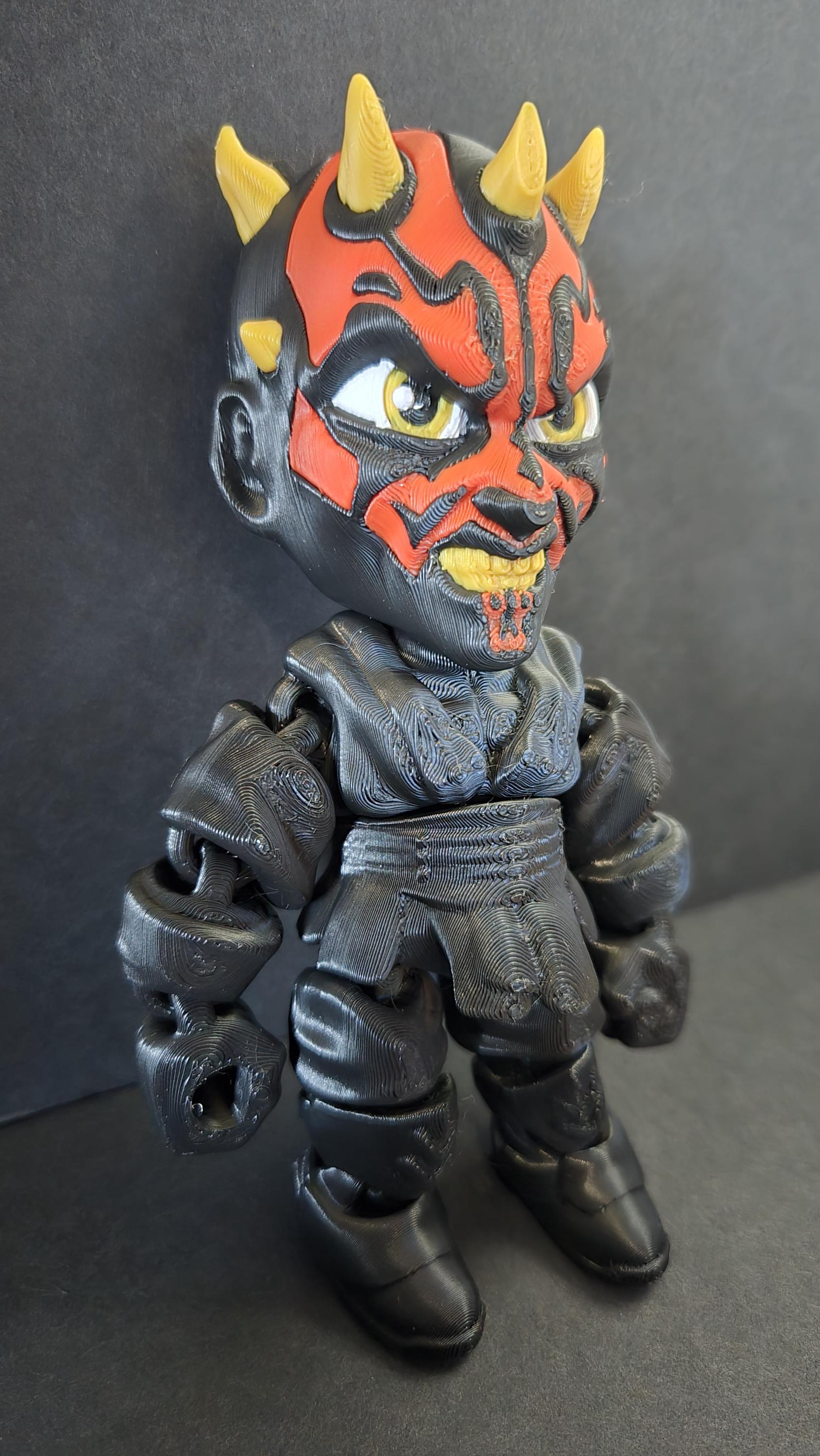 Right side view of the jointed Darth Maul figure slightly flexed to demonstrate the dynamic movement of the leg and arm segments