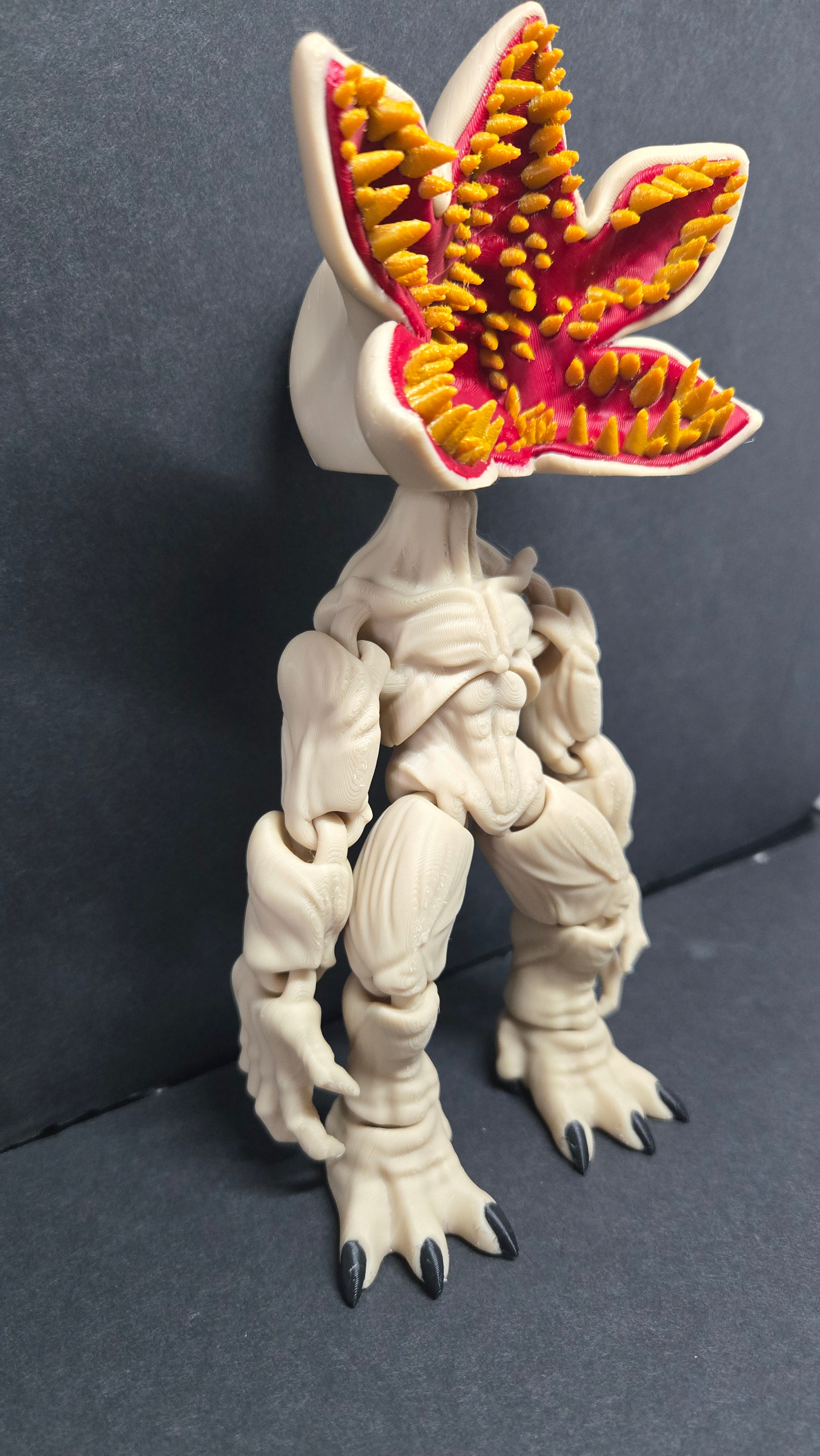 Angled side view of the Demogorgon flexi figure showing its body posture and detailed head
