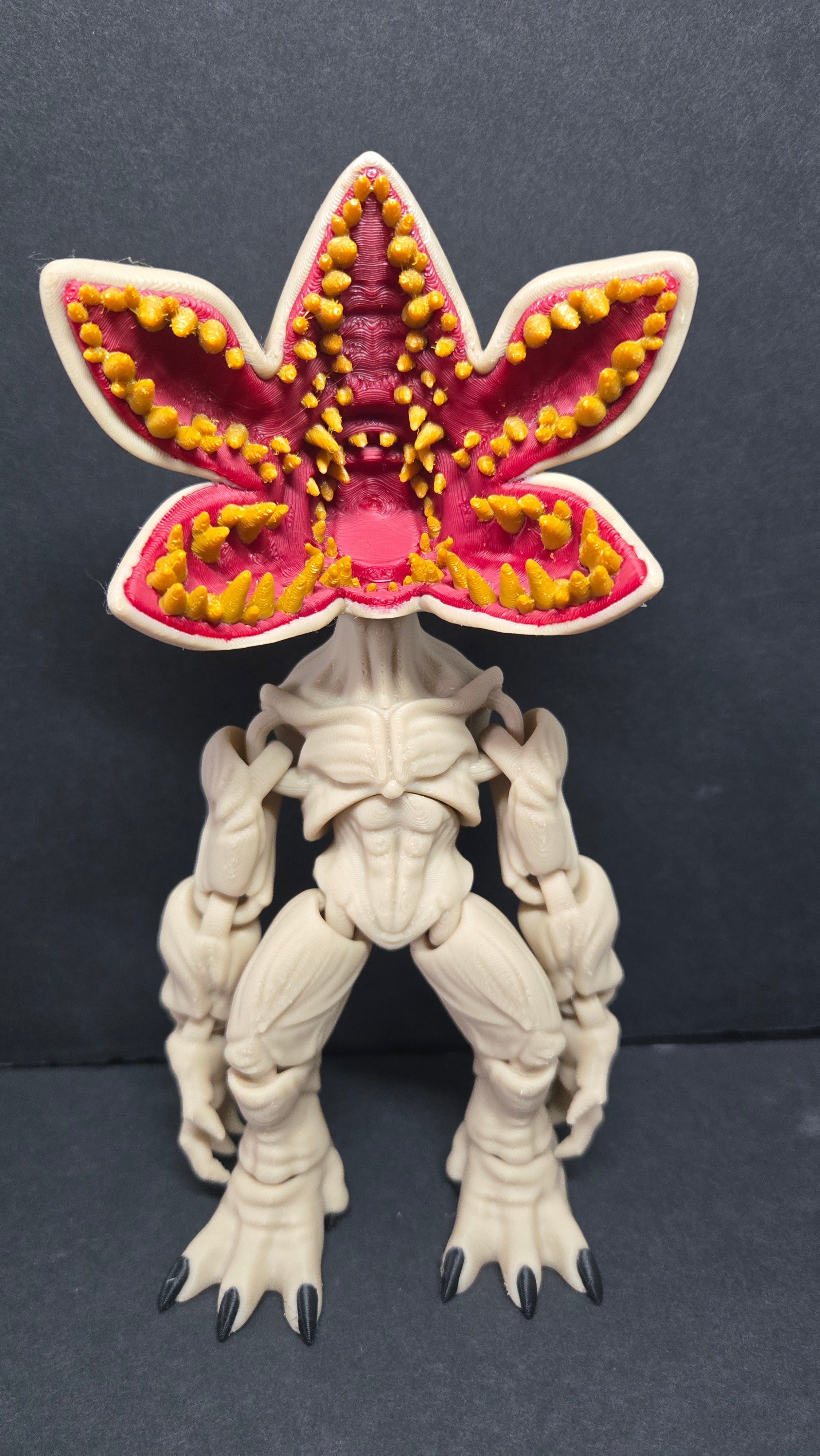 Front view of the articulated Demogorgon flexi figure on a dark studio surface