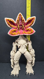 Demogorgon flexi figure standing next to a yellow measuring tape to display its scale height