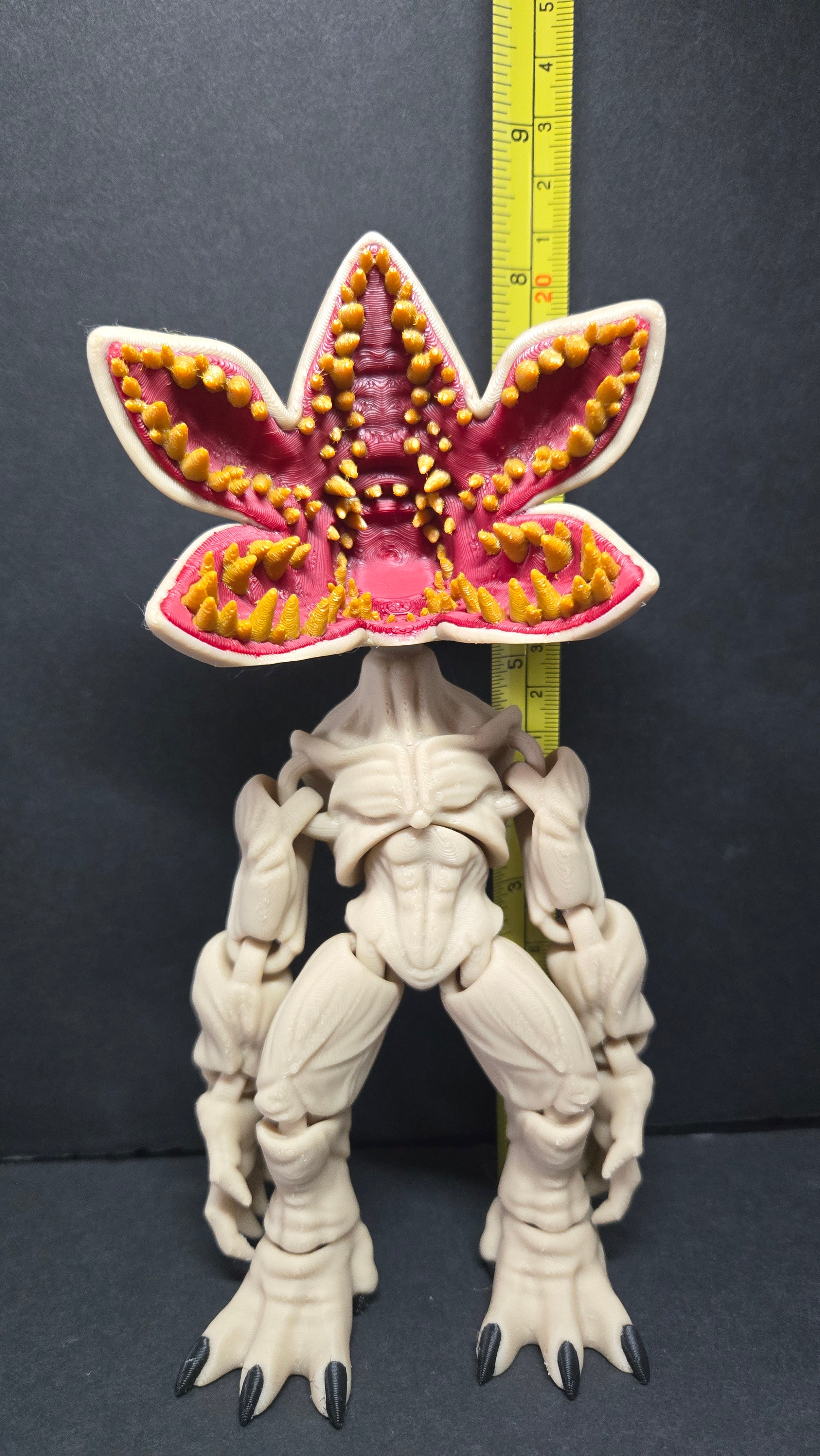 Demogorgon flexi figure standing next to a yellow measuring tape to display its scale height