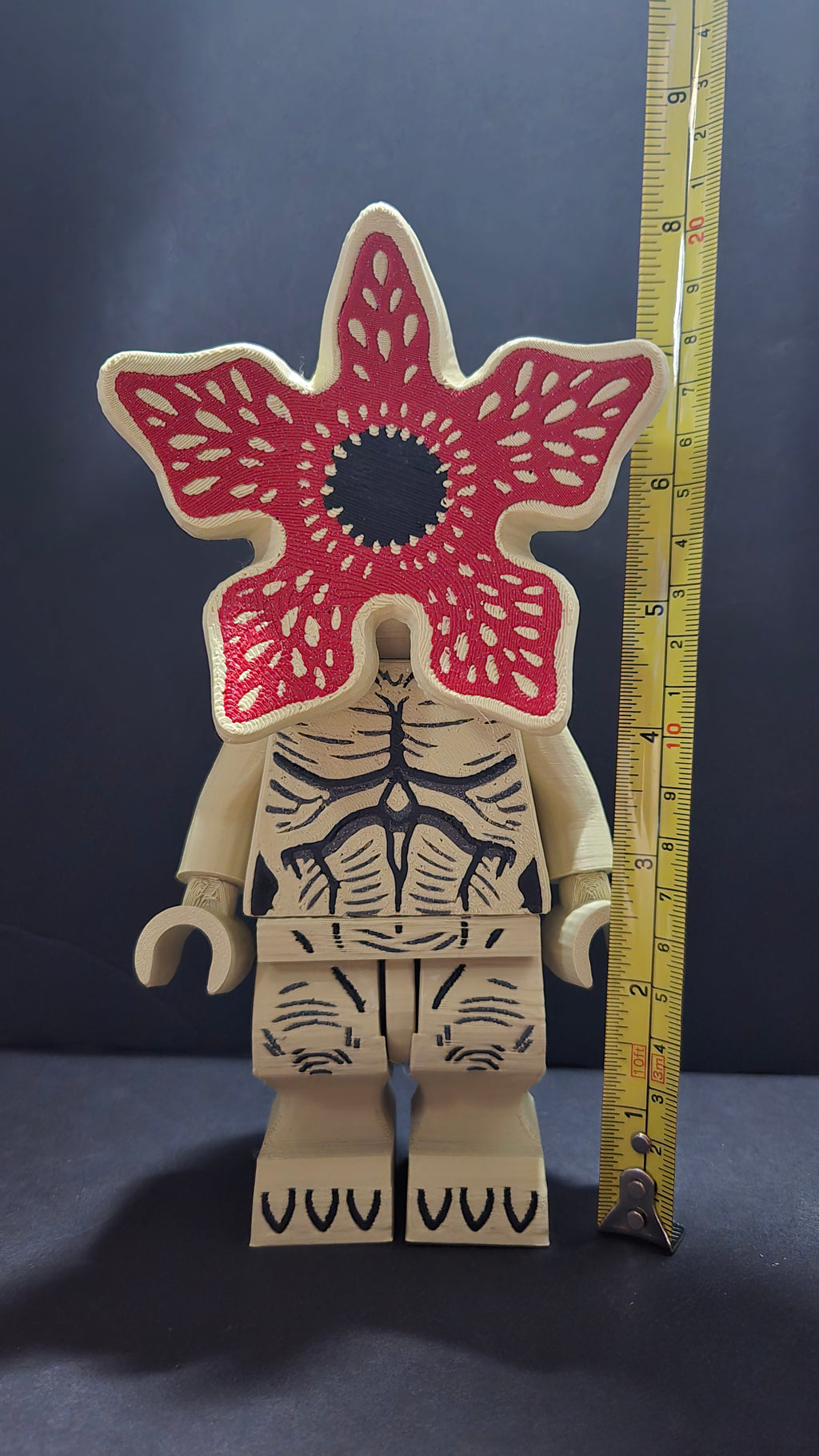 Demogorgon brick megafig standing next to a yellow measuring tape to display its scale height