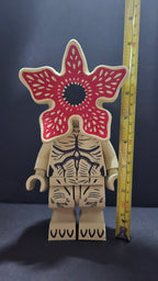Demogorgon brick megafig standing next to a yellow measuring tape to display its scale height