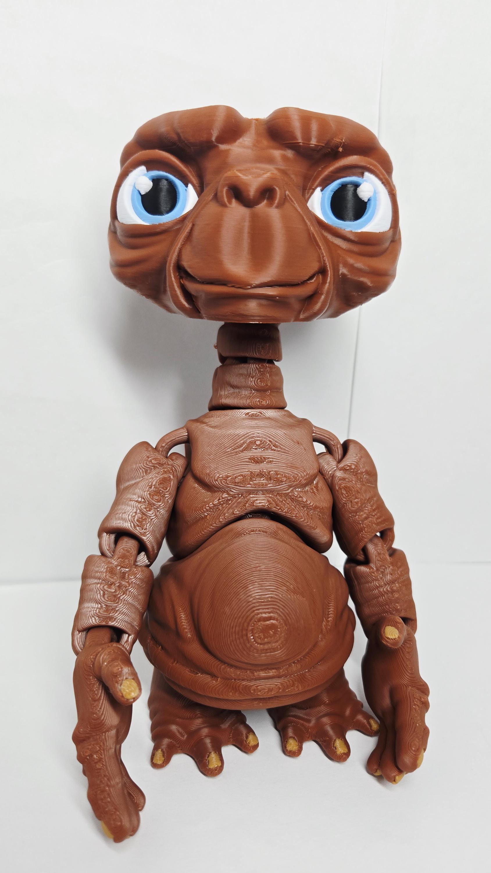 Three-quarter right side view of the flexible E.T. figure showcasing the arm joints, wrinkled skin texture, and expressive eyes