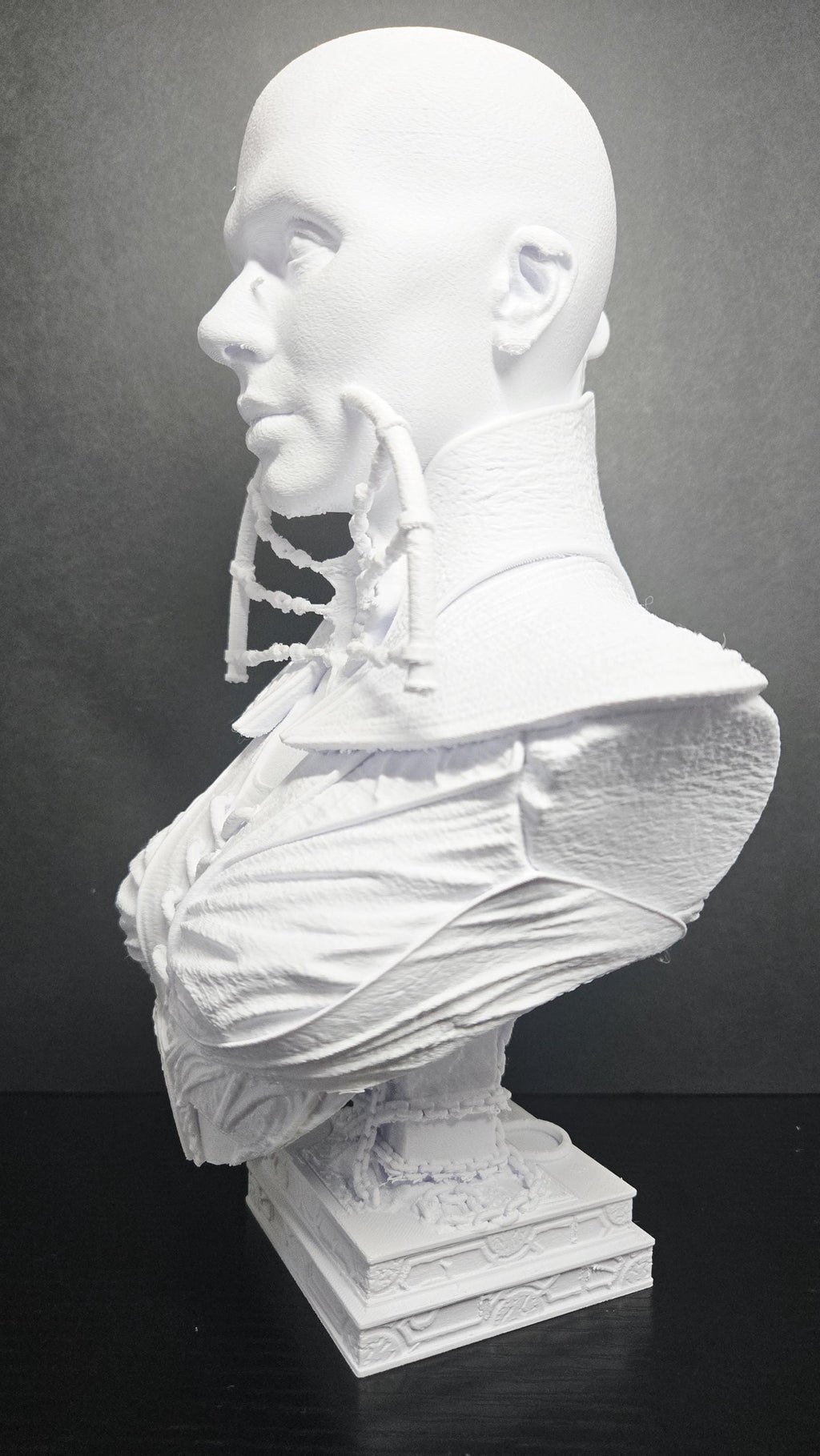 Side profile view of the unpainted Female Cenobite bust showcasing the throat adornments and facial contours