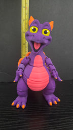 Figment flexi figure standing next to a yellow measuring tape to display its 7.25-inch height