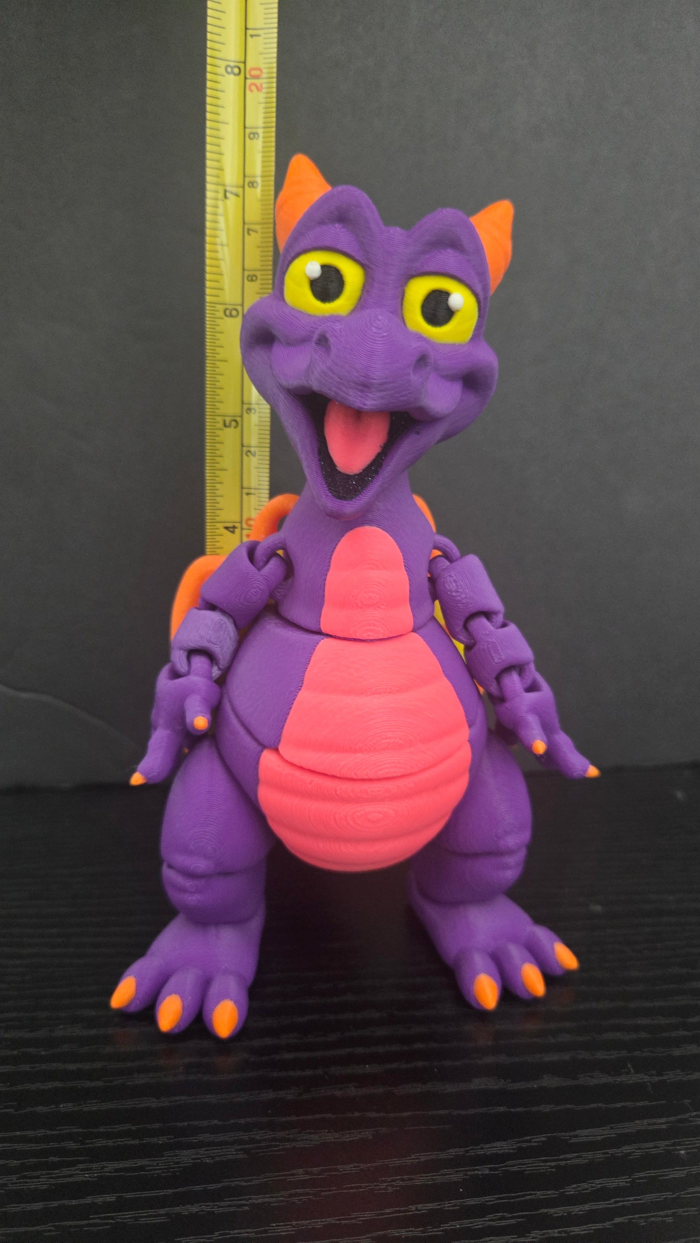 Figment flexi figure standing next to a yellow measuring tape to display its 7.25-inch height