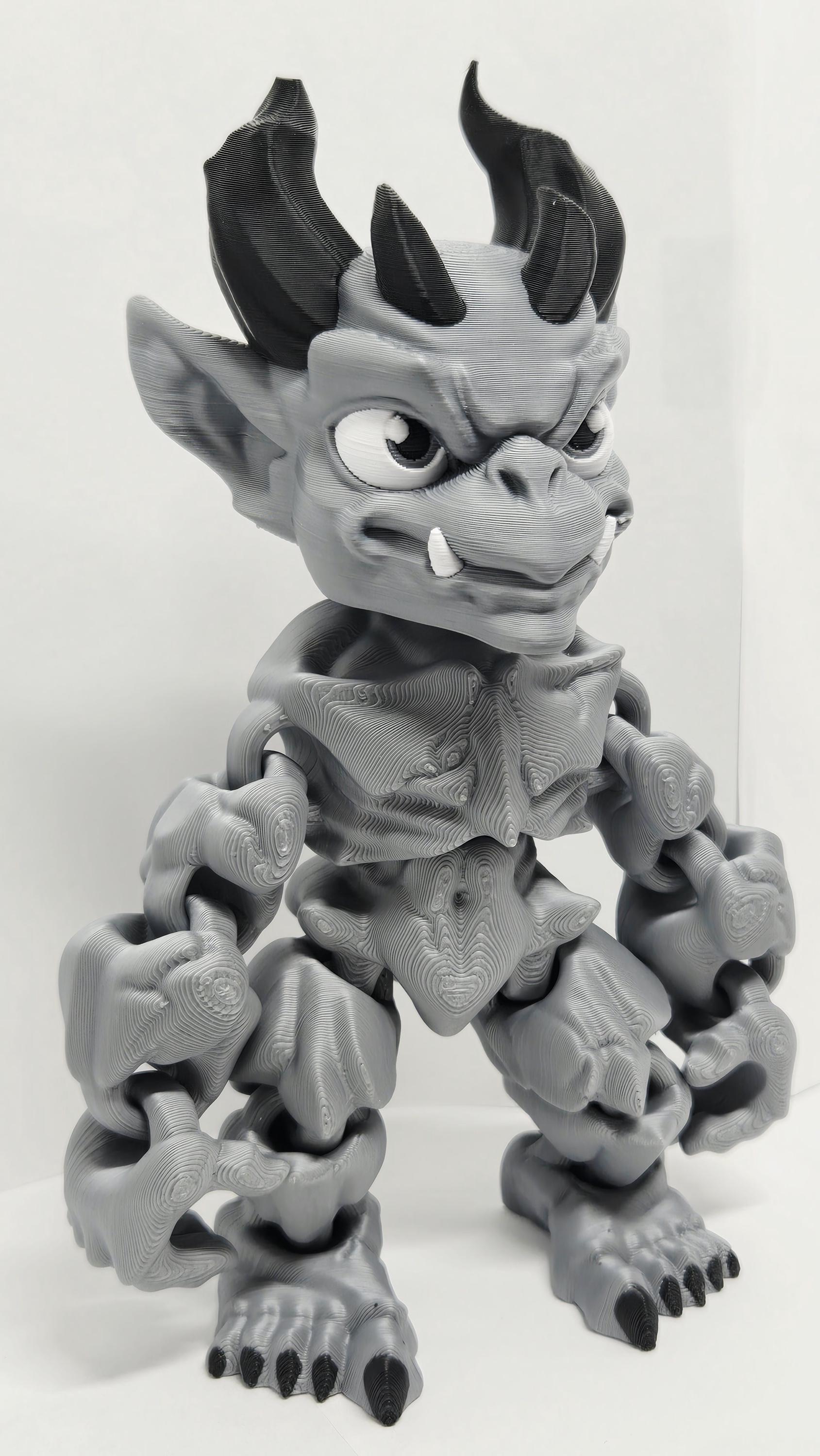 Right side view of the jointed gargoyle figure slightly flexed to demonstrate the dynamic structural movement of the plastic segments
