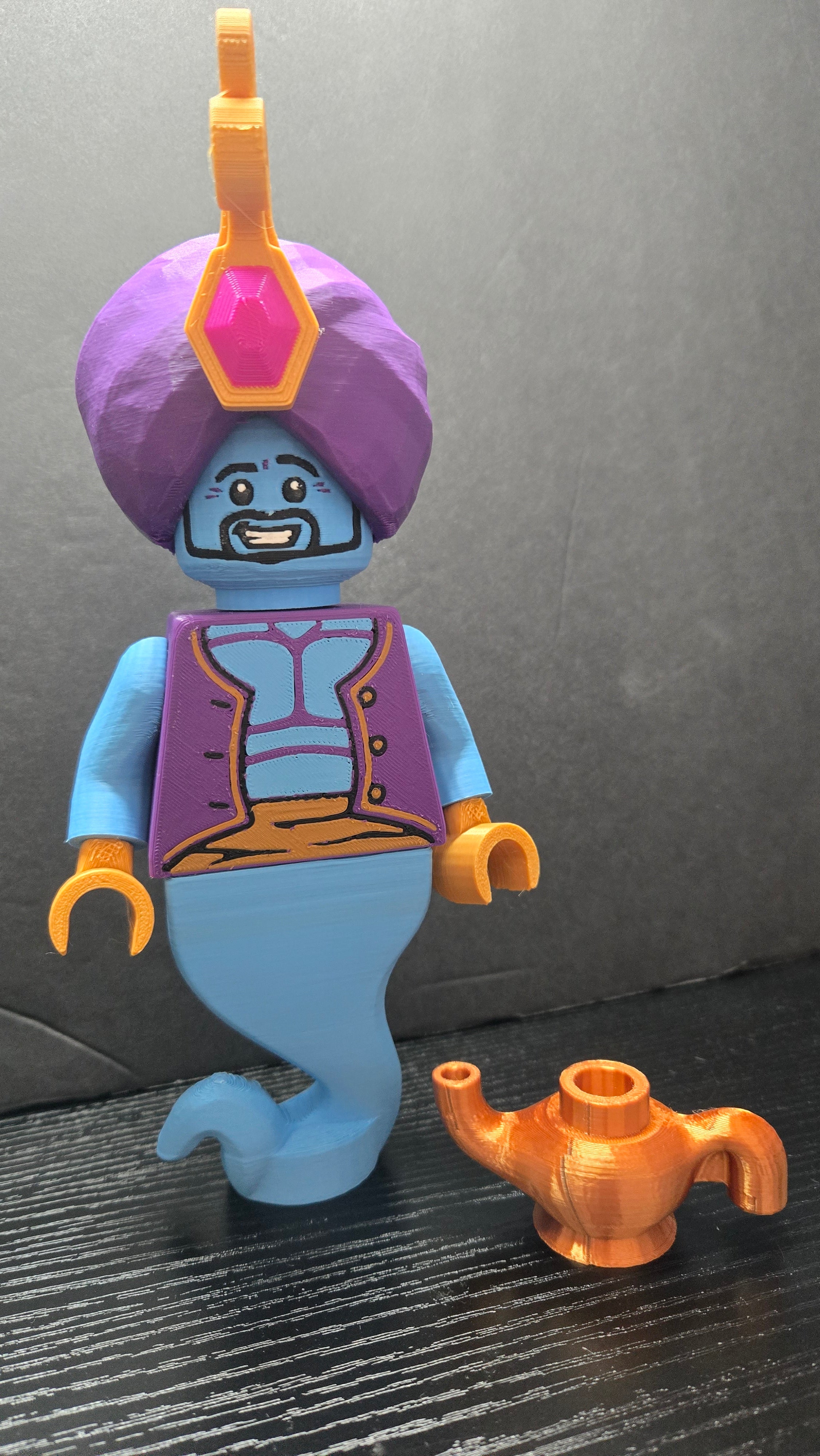 Straight front view of the Genie brick megafig standing next to its golden magic lamp