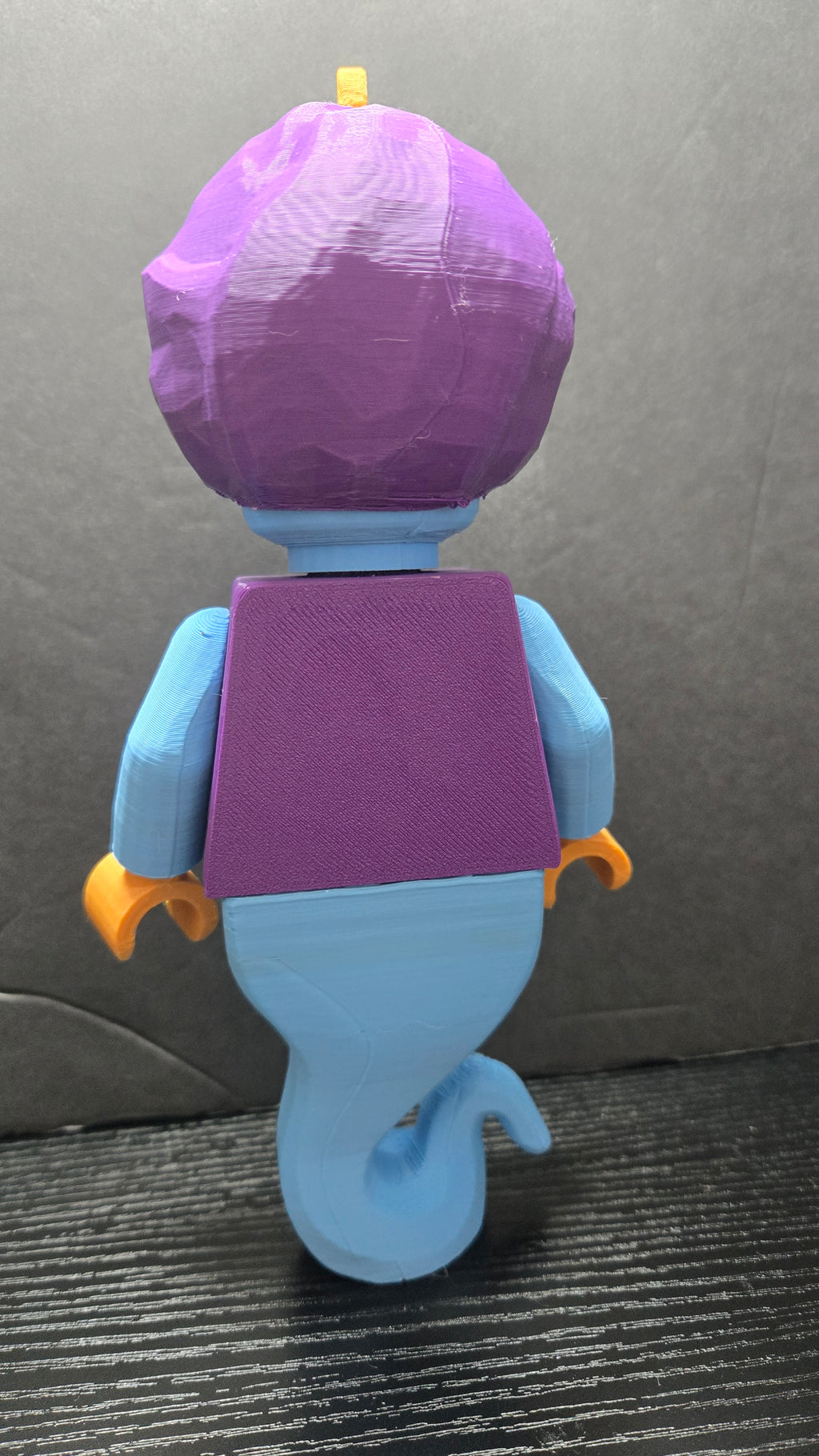Rear view of the Genie brick megafig showing the back of the purple vest and magical tail