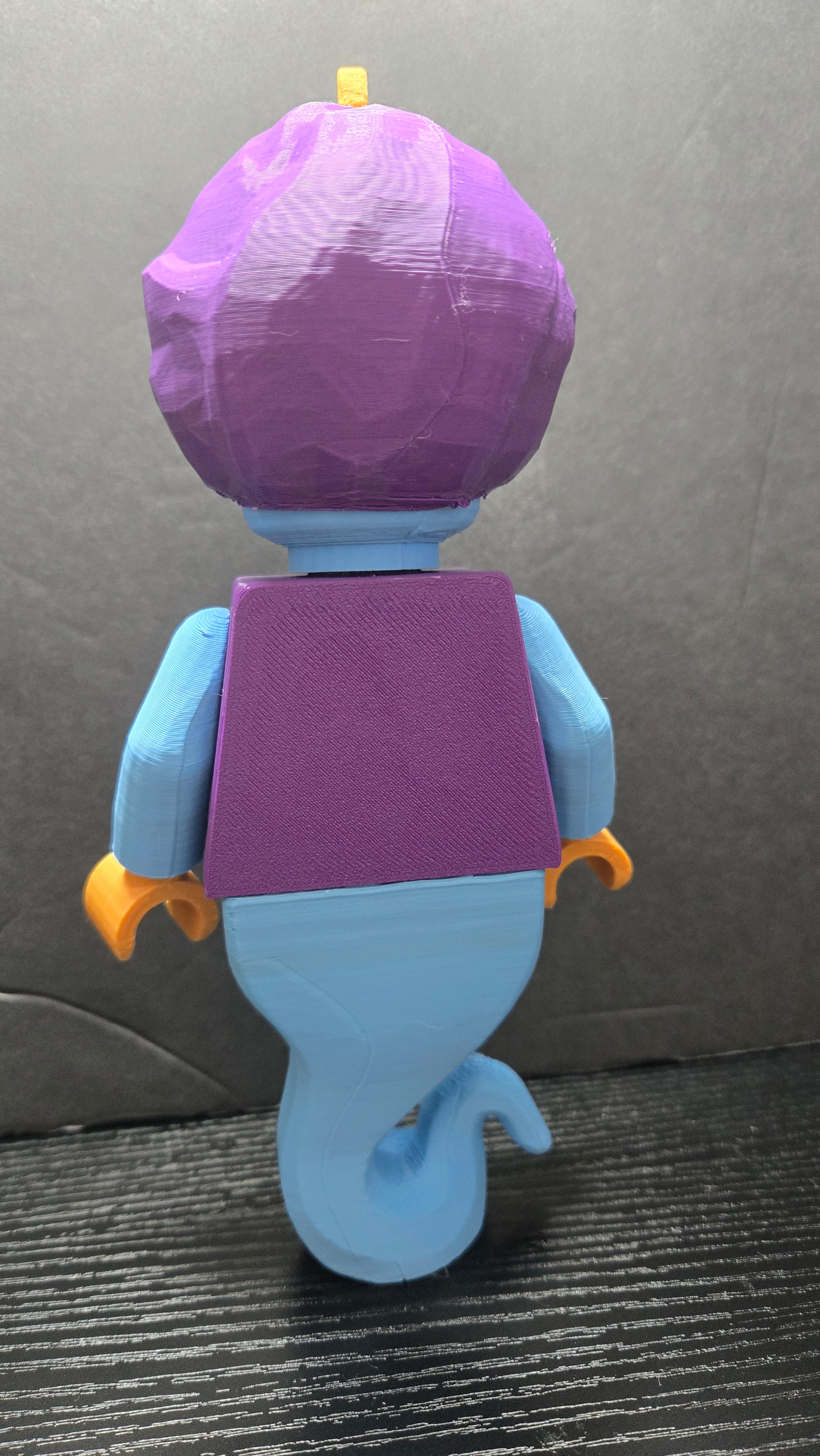 Rear view of the Genie brick megafig showing the back of the purple vest and magical tail