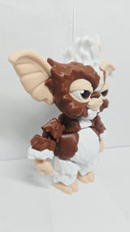 Right side view of the jointed Gizmo Mogwai figure slightly flexed to demonstrate the dynamic structural movement of the leg and arm segments