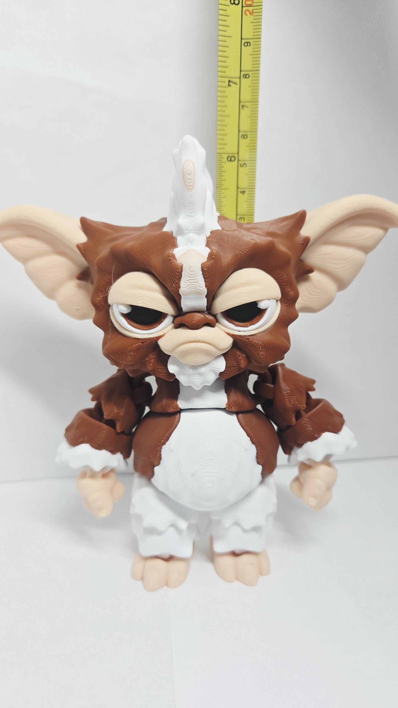 Straight front view focusing on the large oversized ears, warm brown eyes, and sweet facial expression of the flexible Gizmo figure
