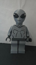 Straight front view of the scaled oversized Grey Alien figure showcasing the jumpsuit detail