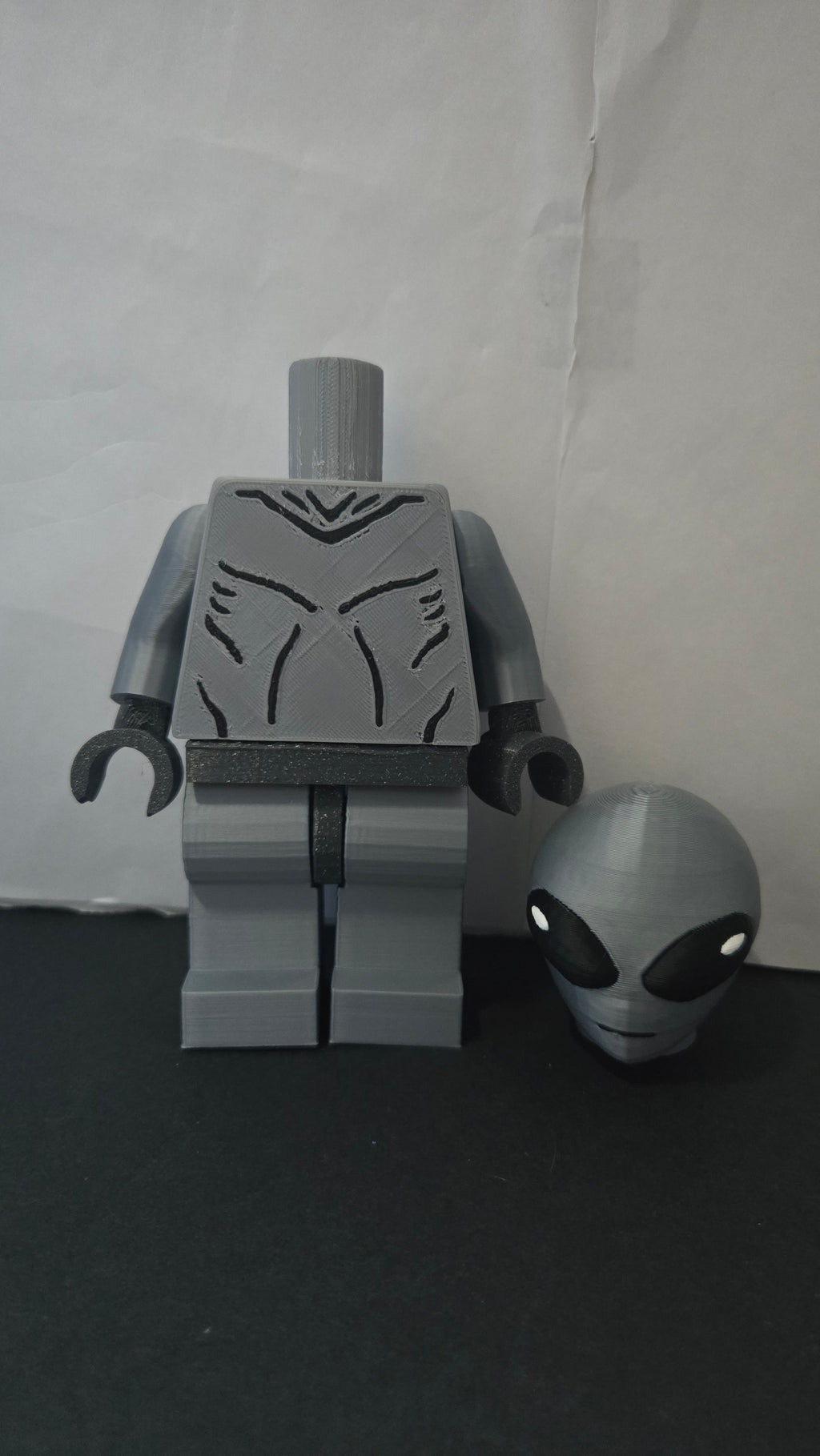 Oversized Grey Alien megafig shown with its head detached to display the modular neck joint