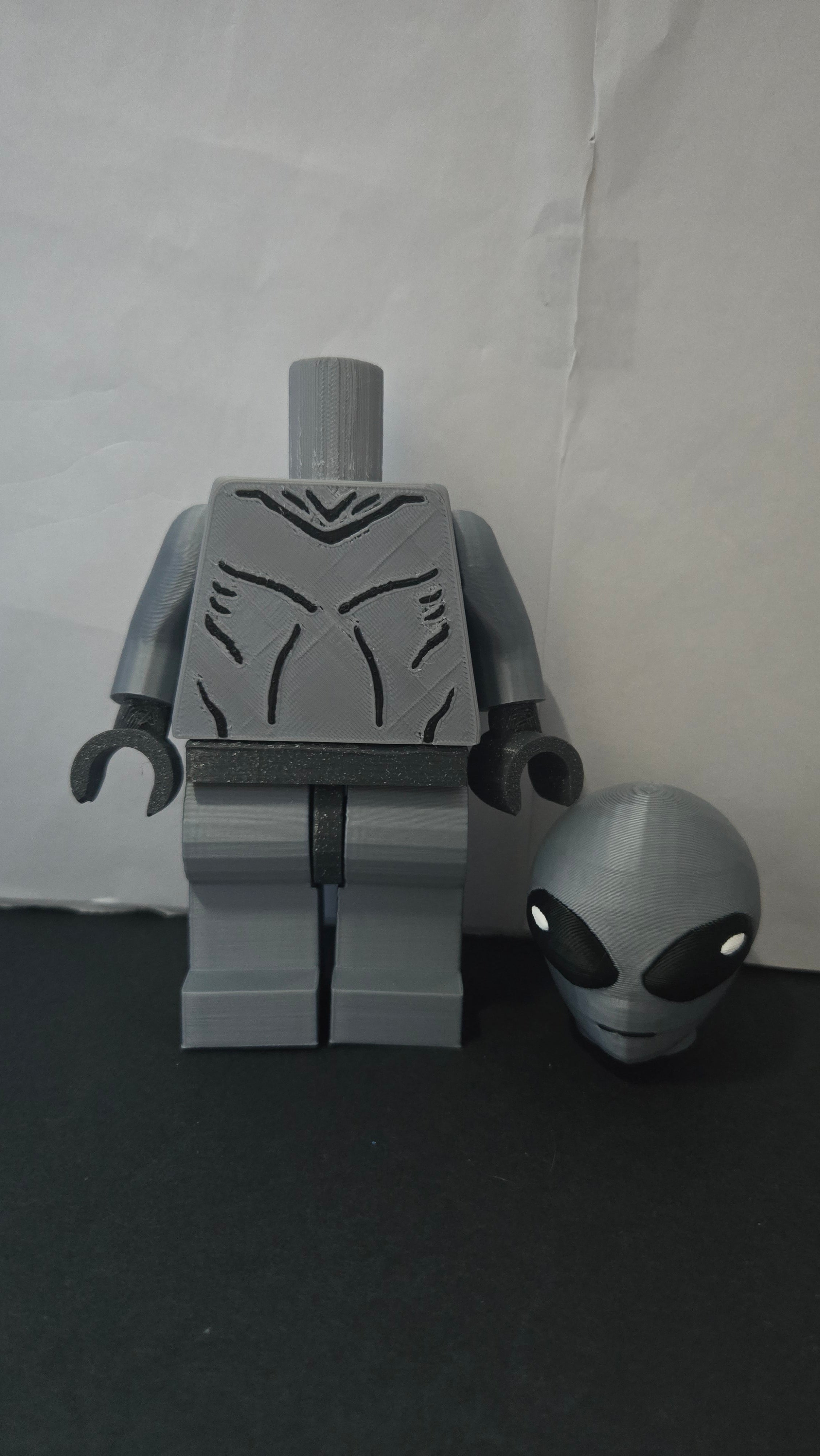 Oversized Grey Alien megafig shown with its head detached to display the modular neck joint