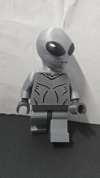 Three-quarter view of the oversized Grey Alien brick megafig showing its stride and head shape