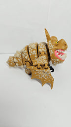 Right side view of the jointed Gronckle figure slightly curved to demonstrate the dynamic structural movement of the tail and leg segments