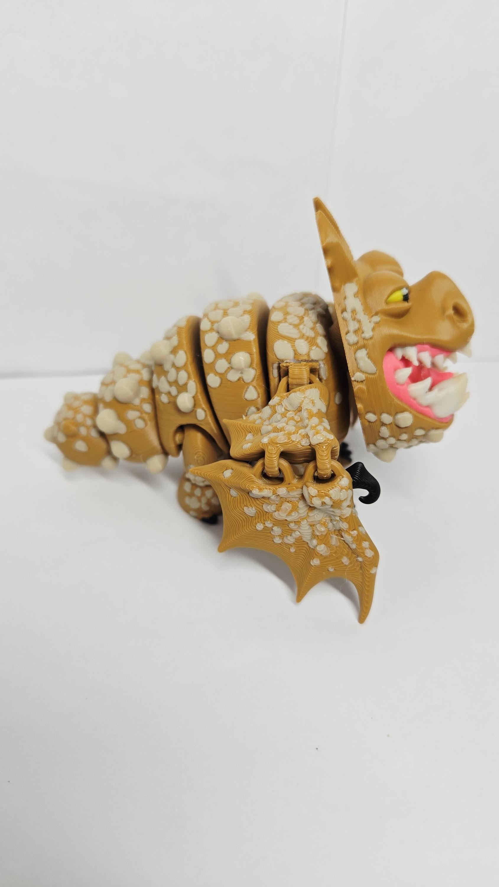 Right side view of the jointed Gronckle figure slightly curved to demonstrate the dynamic structural movement of the tail and leg segments