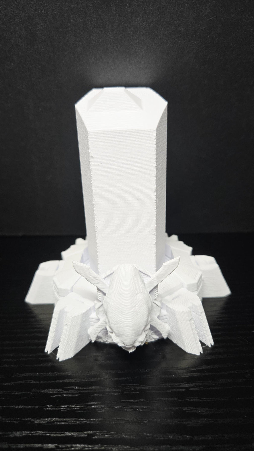 Front-facing close-up of the unpainted 3D printed futuristic display pedestal base showing the clean geometric design