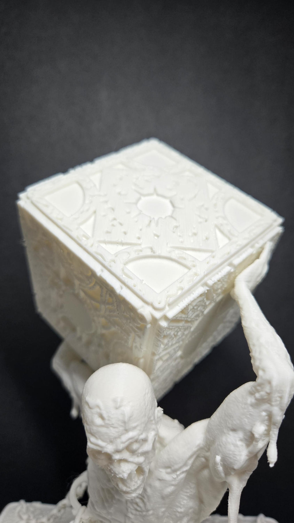 Close-up of the unpainted diorama base showing the chain textures and base debris detail