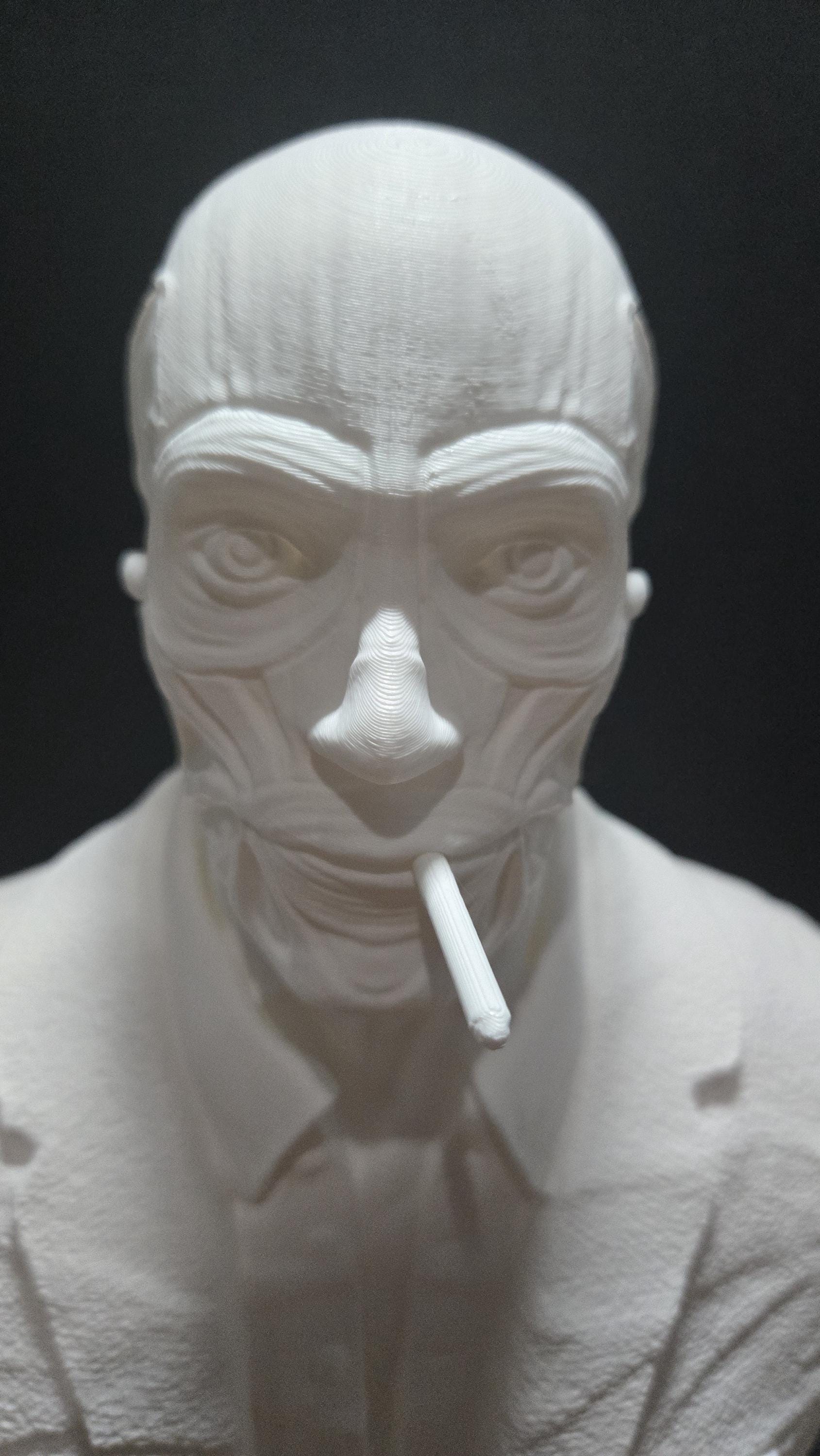 Macro front close-up of the unpainted Frank Cotton face sculpt emphasizing the hollow eyes, nose structure, and deep tissue channels