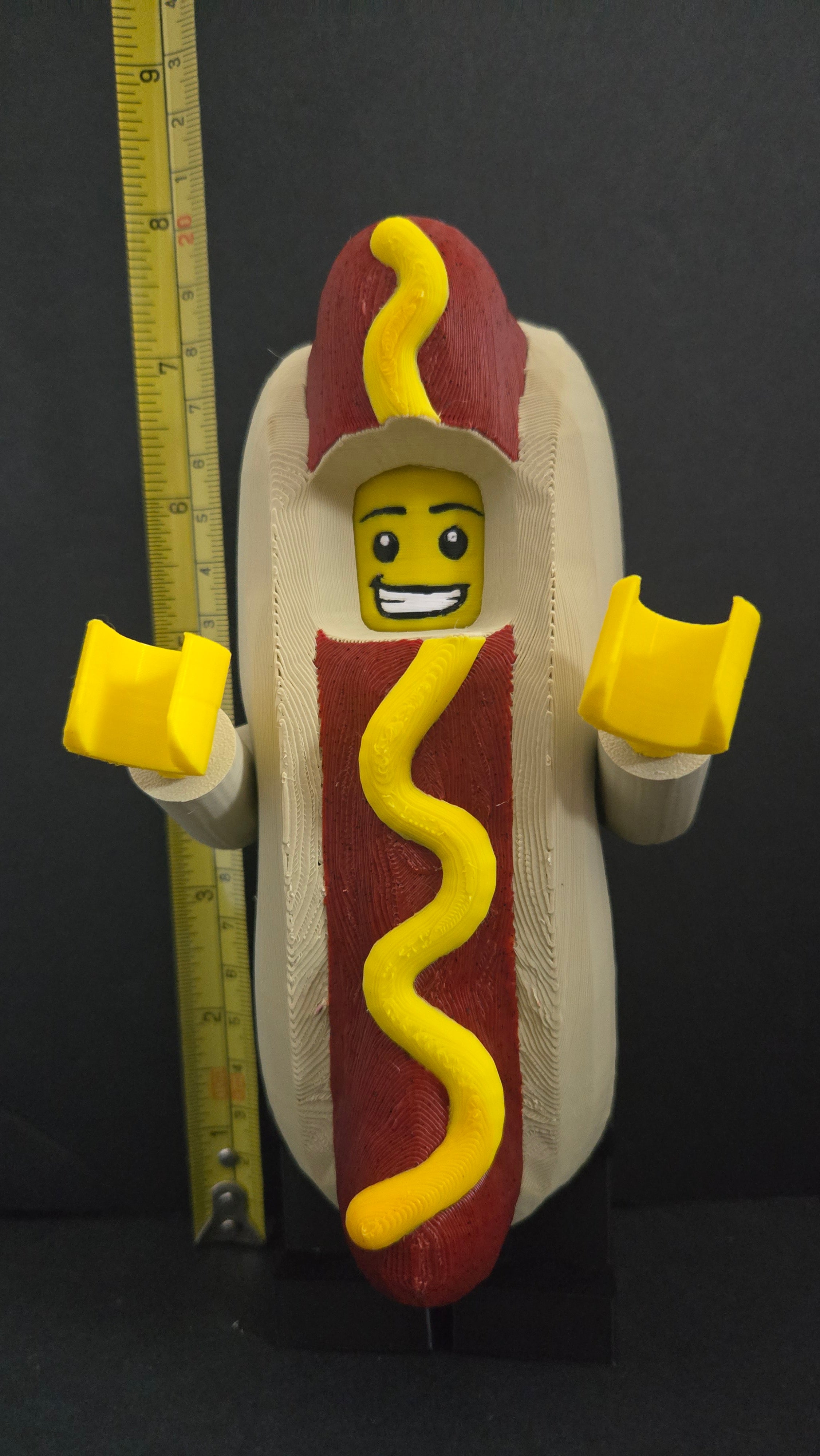 Measuring tape showing the towering height of the scaled oversized Hot Dog Guy megafig