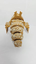 Rear view of the 3D printed Gronckle figurine showcasing the clean jointed interlocking segments and small wings along its back