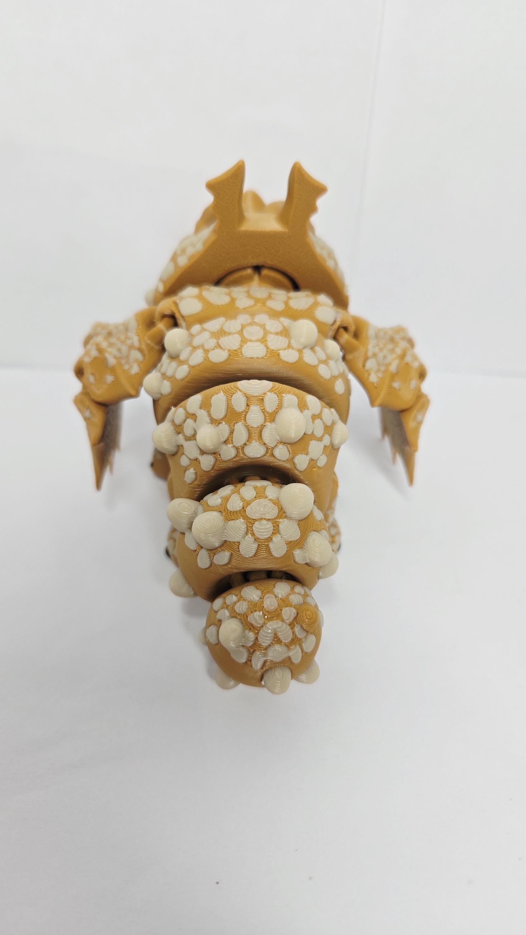 Rear view of the 3D printed Gronckle figurine showcasing the clean jointed interlocking segments and small wings along its back