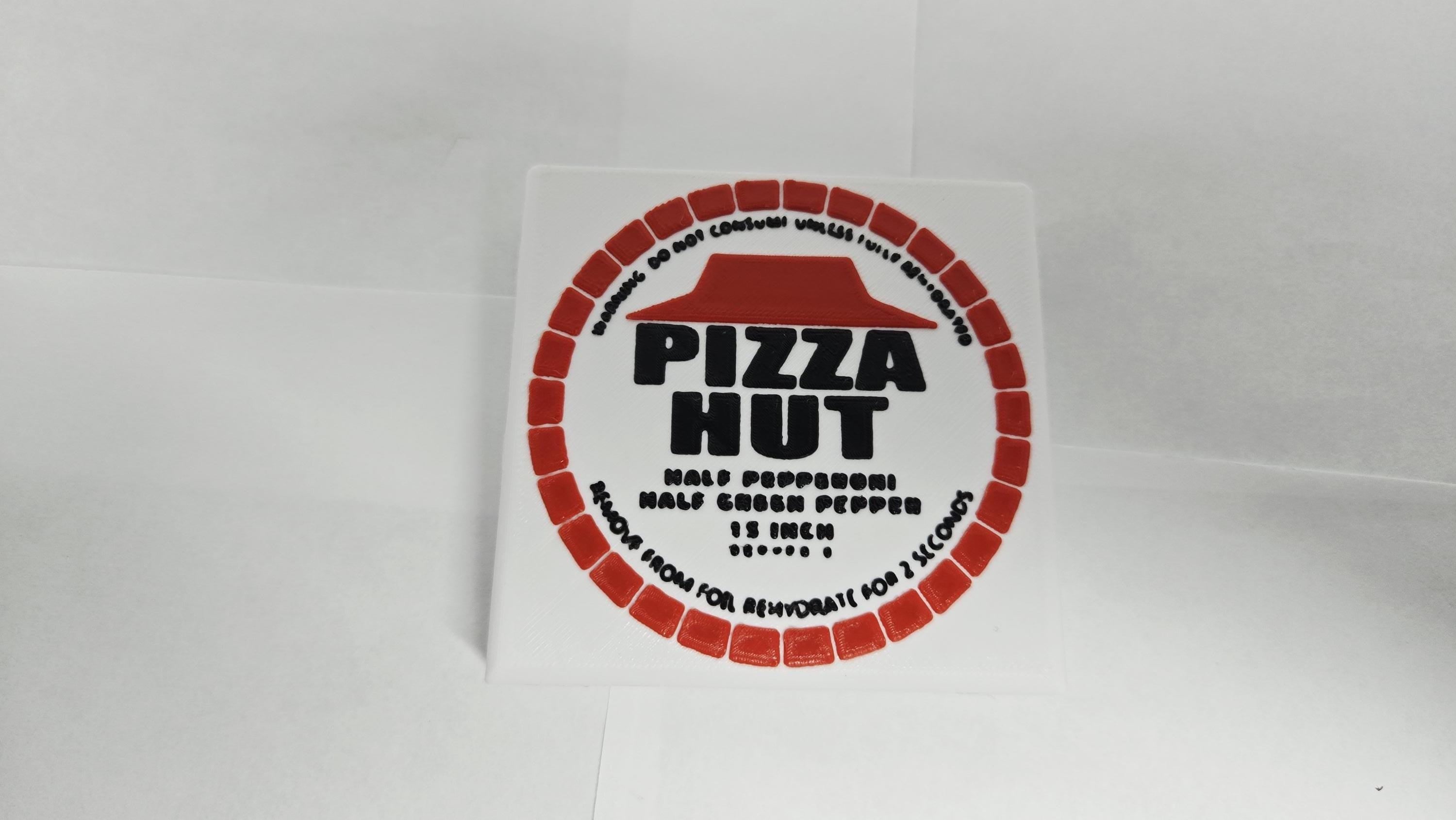 Close-up of the dehydrated Pizza Hut disk prop with authentic logo details