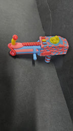 Top-down view of the 3D printed popcorn gun accessory showing its colorful details
