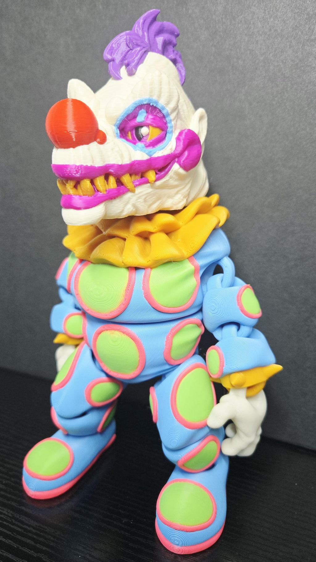 Side profile view of the 3D printed Klownzilla flexi figure showing his articulation and monster detail
