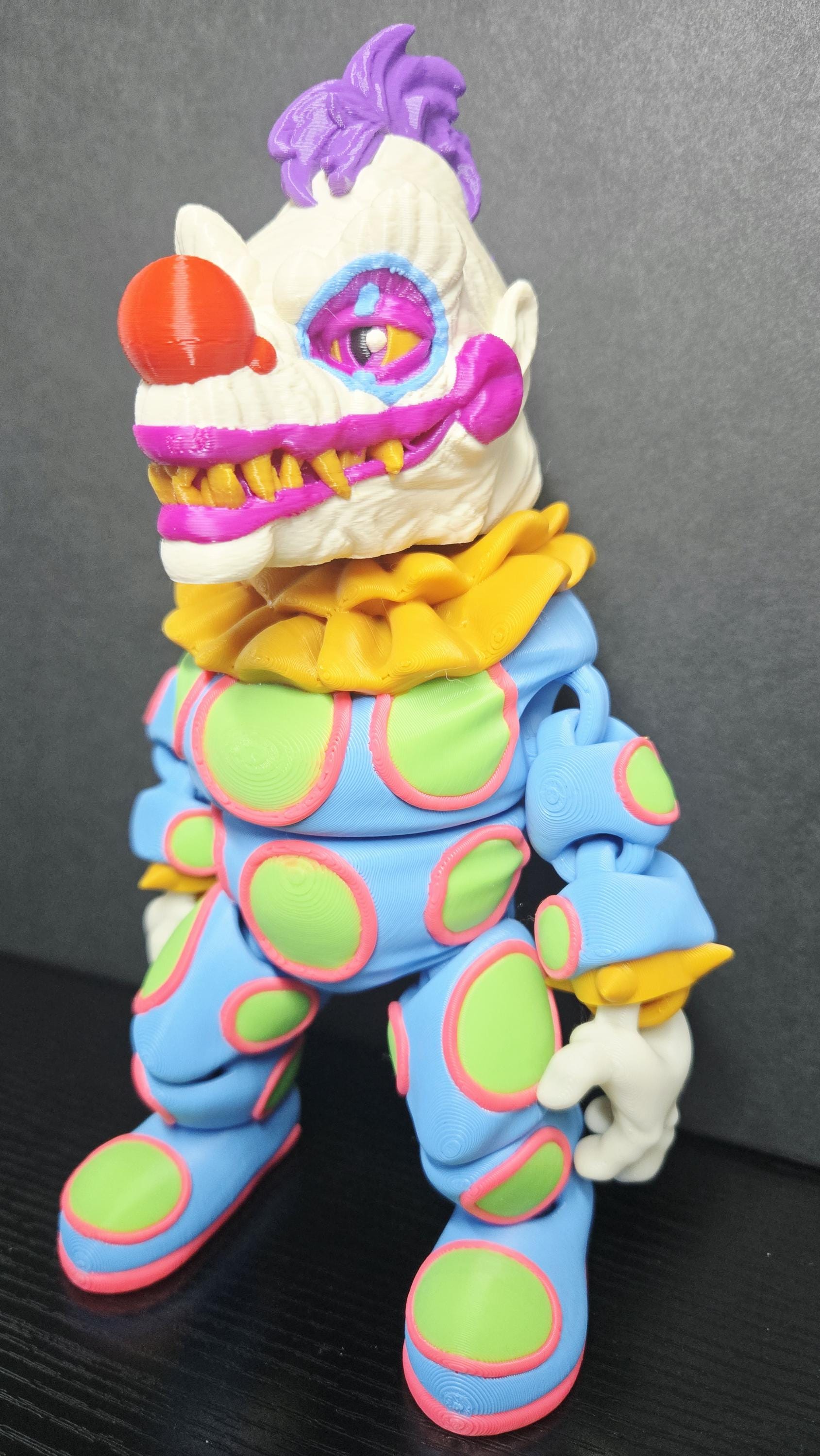 Side profile view of the 3D printed Klownzilla flexi figure showing his articulation and monster detail
